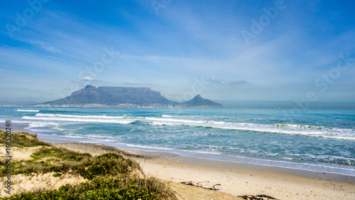 Early morning view of Cape Town and Table Mountain with Lion's Head and Signal Hill on the right and Devil's Peak on the left. Viewed from Bloubergstrand just north of the city photo