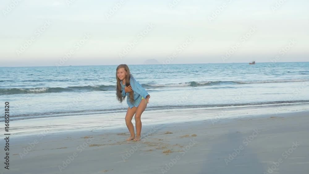Cute young girl doing gymnastic cartwheel on the beach Cute young girl doing gymnastic cartwheel on the beach