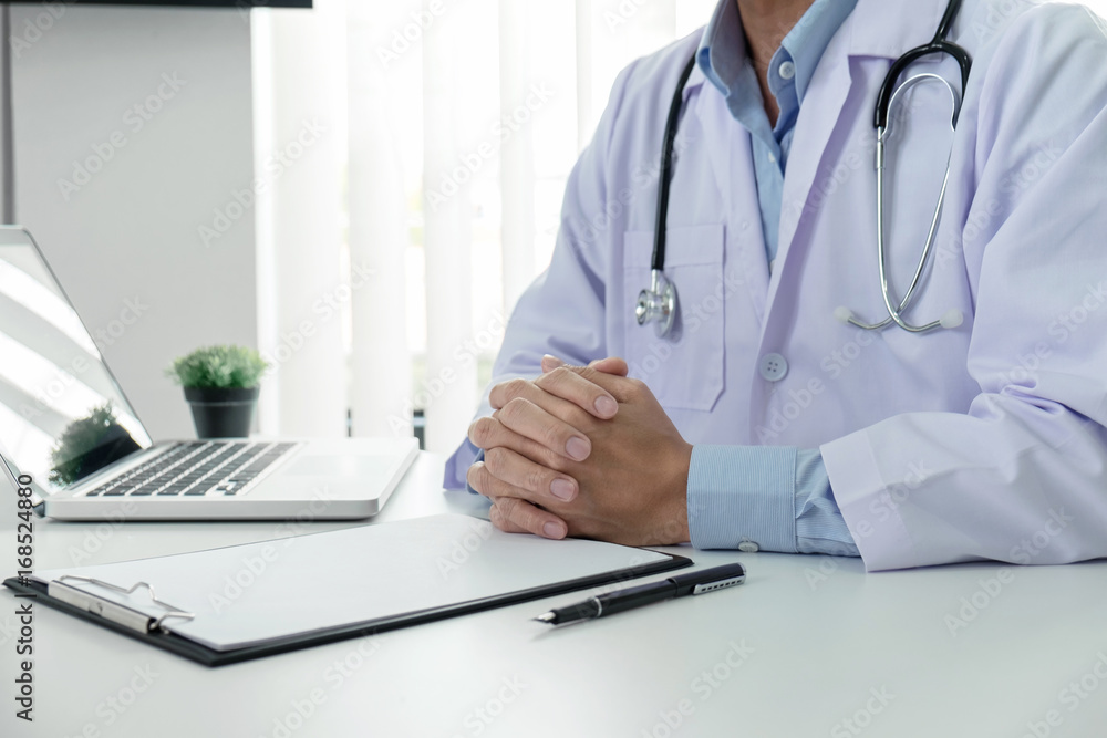 Close up of doctor filling up an history form while consulting patient and think about finding a cure for a diagnosis, treatment methods to rehabilitate the body Close up of doctor filling up an history form while consulting patient and think about finding a cure for a diagnosis, treatment methods to rehabilitate the body