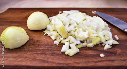 Chopped onions on wooden cutting board