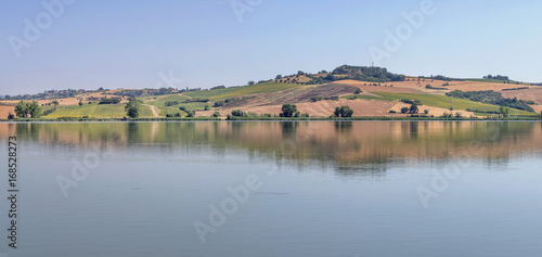 Beautiful panorama of Lake Chiusi, Siena, Italy, on a sunny summer day