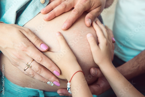 Man embracing his pregnant wife
