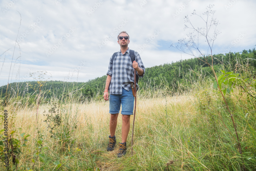 Young hiker in nature / wilderness - trekking outdoors. Young hiker in nature / wilderness - trekking outdoors.