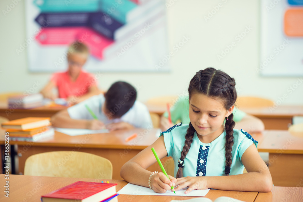 Happy clever children learning in classroom Happy clever children learning in classroom