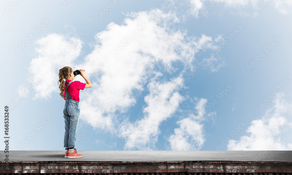 Concept of careless happy childhood with girl of school age looking in future
