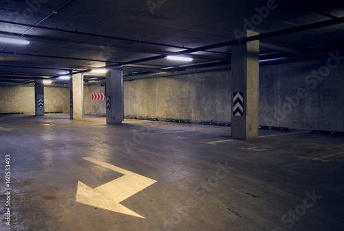 Urban underground background with white arrow on the ground