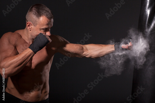 Fotografie boxer punch hand by punching bag,