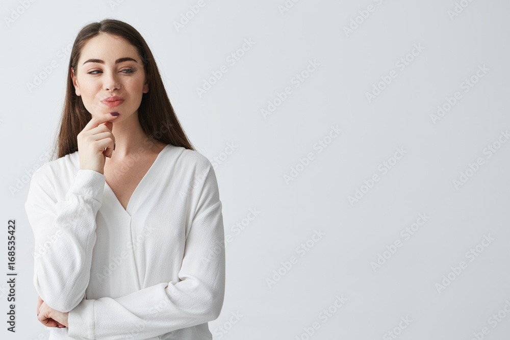 Young beautiful playful businesswoman with cunning tricky glance smiling over white background. Young beautiful playful businesswoman with cunning tricky glance smiling over white background.