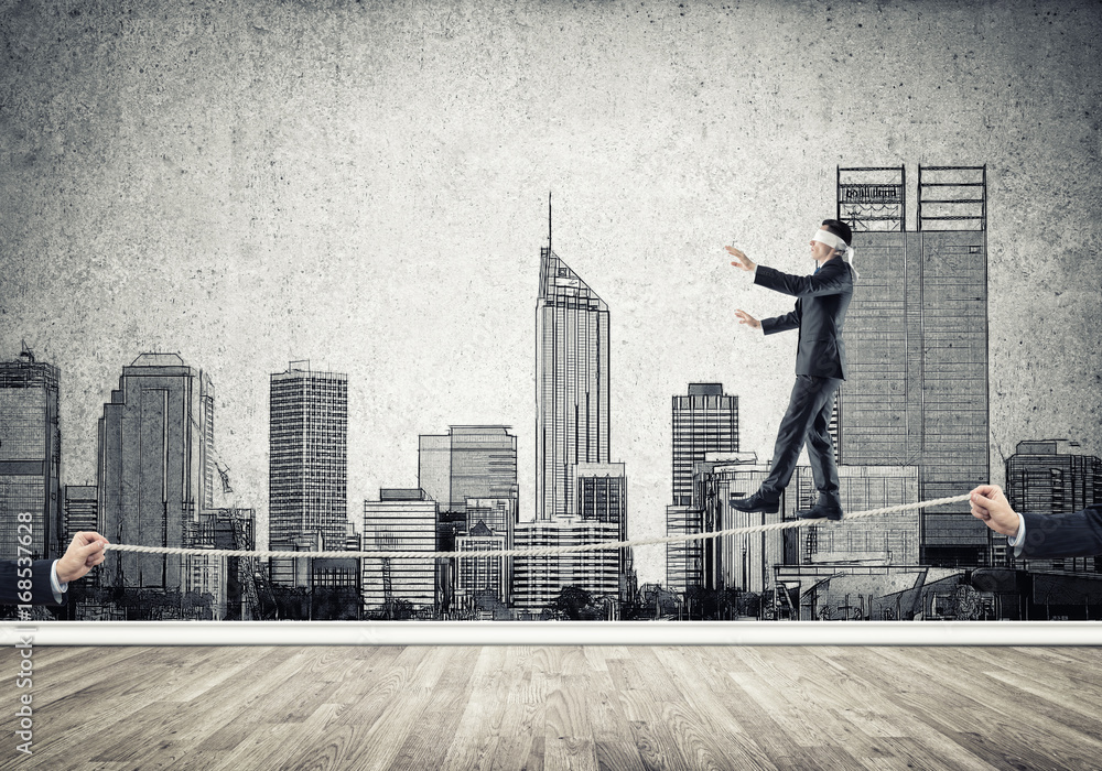 Business concept of risk support and assistance with man balancing on rope Business concept of risk support and assistance with man balancing on rope