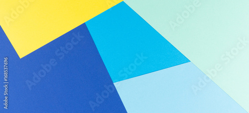 Color papers geometry flat composition background with yellow and blue tones