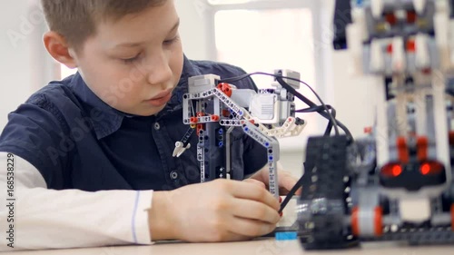 Wallpaper Mural Young boy engineer playing with robot. Close-up. Torontodigital.ca