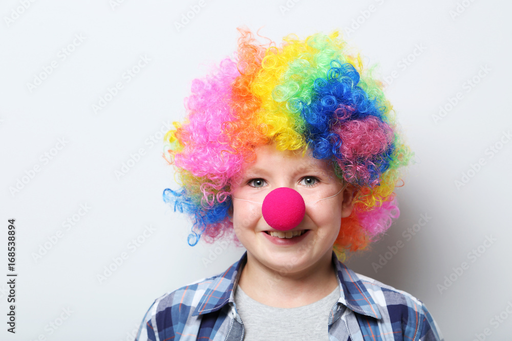 Portrait of  little boy clown on grey background