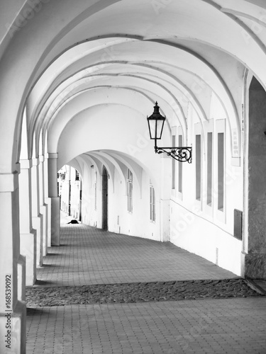 Old historical arcade in Loretanska Street near Prague Castle, Prague, Czech Republic. Black and white image photo