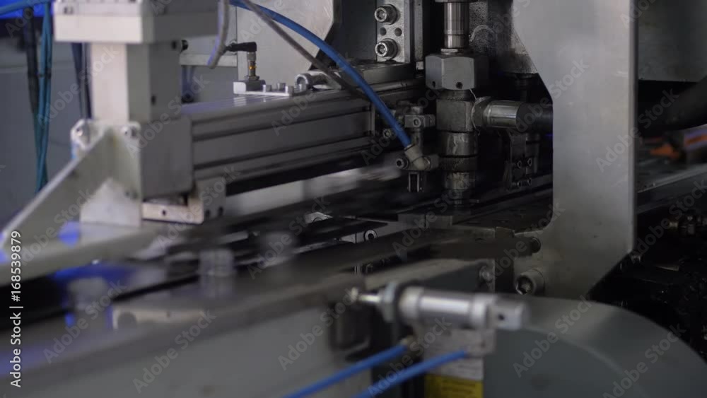 The process of blowing plastic bottles in extrusion equipment. Molten white plastic like a tube is placed in a press form and blowing the air and is give to shape of the bottle.Beverage factory The process of blowing plastic bottles in extrusion equipment. Molten white plastic like a tube is placed in a press form and blowing the air and is give to shape of the bottle.Beverage factory