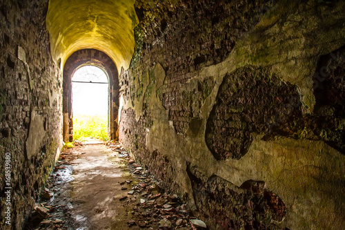 Tunnel with peeling walls. ...