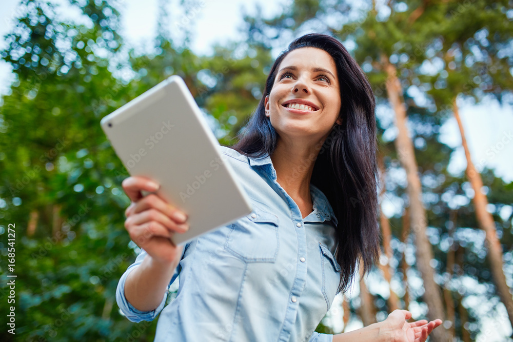Young woman with tablet in the park Young woman with tablet in the park