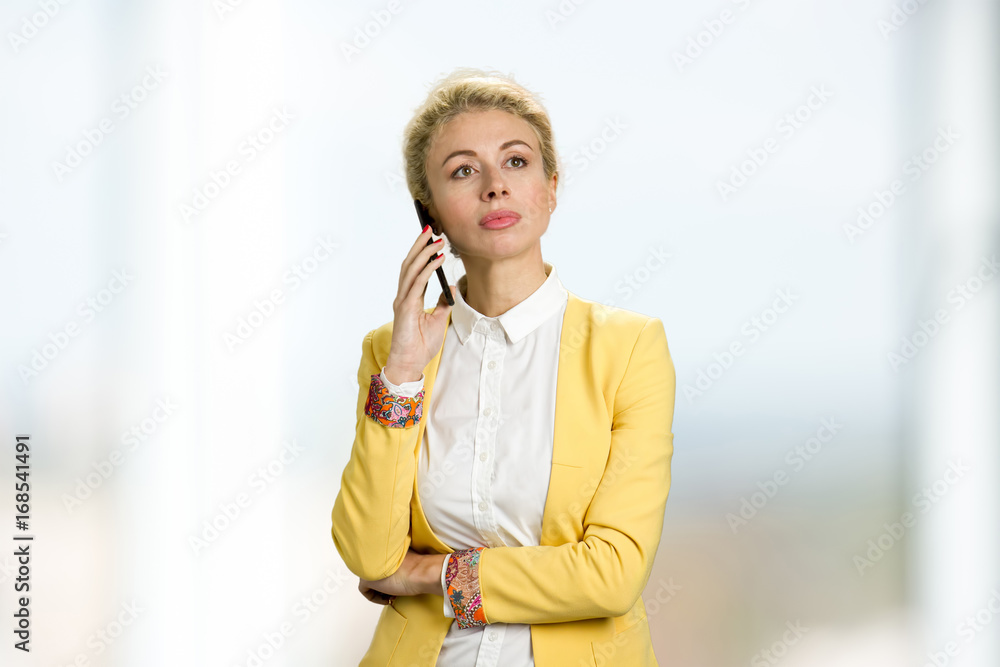 Beautiful business lady with phone. Portrait of young business woman talking on the mobile phone. Beautiful business lady with phone. Portrait of young business woman talking on the mobile phone.