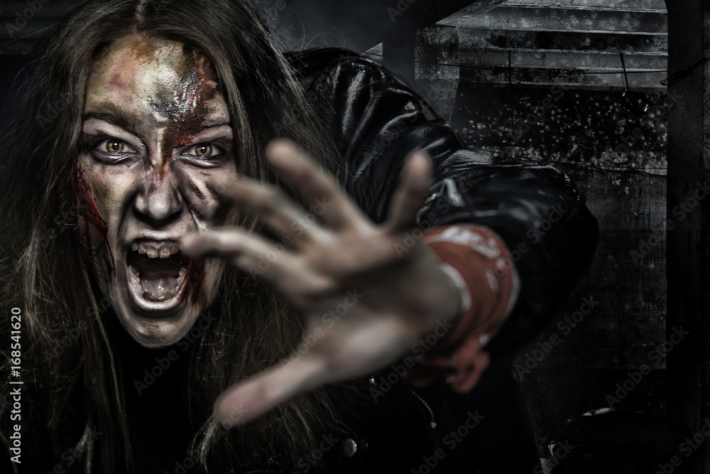 Obraz premium Close-up portrait of horrible zombie woman with wounds. Horror. Halloween poster.