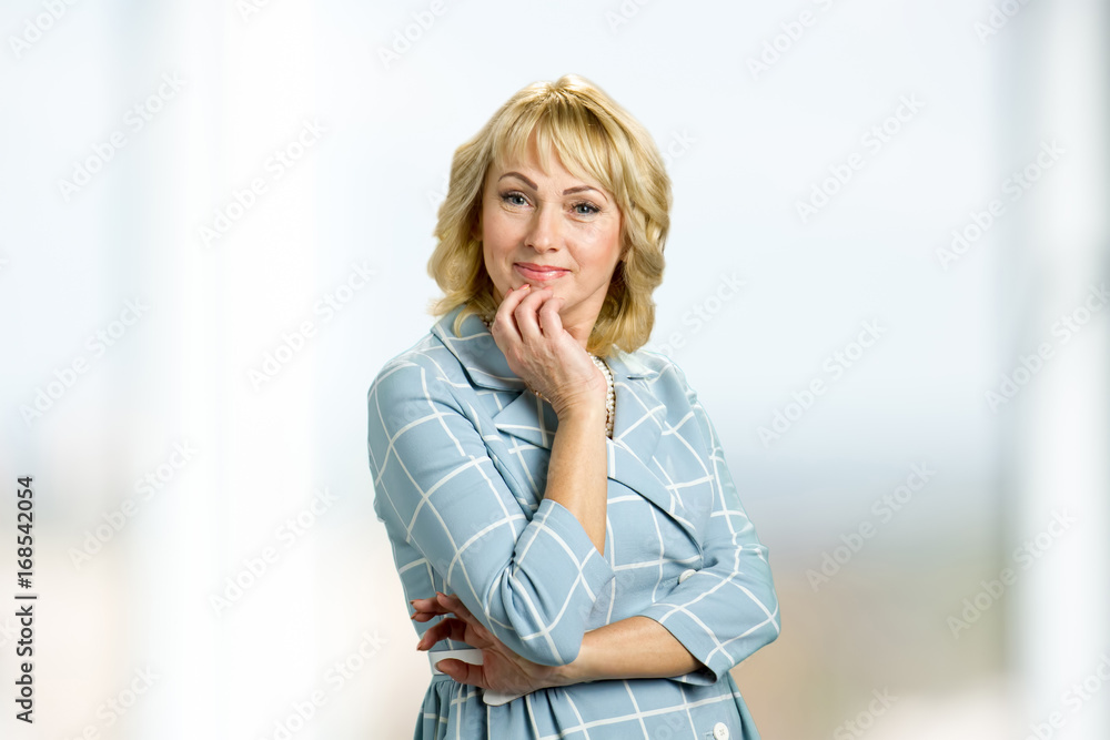 Portrait of beautiful mature woman. Middle aged lady touching her chin with hand and looking at camera. Thoughtful elderly woman. Portrait of beautiful mature woman. Middle aged lady touching her chin with hand and looking at camera. Thoughtful elderly woman.