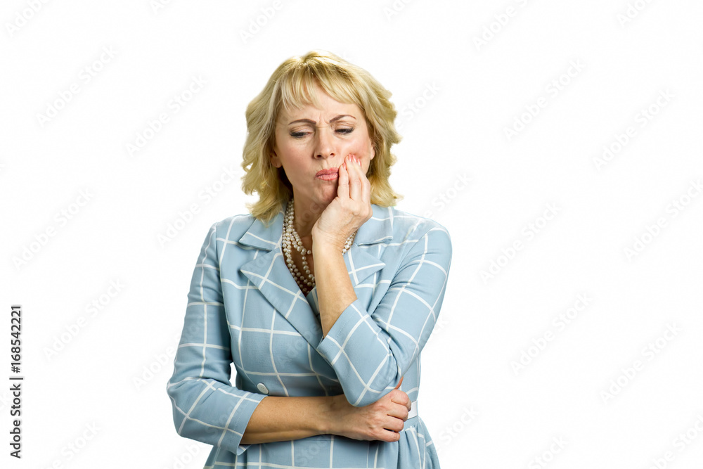 Mature woman having tooth pain. Confident middle aged woman suffering from terrible strong teeth pain, touching cheek standing on white background. Dentistry problem concept. Mature woman having tooth pain. Confident middle aged woman suffering from terrible strong teeth pain, touching cheek standing on white background. Dentistry problem concept.