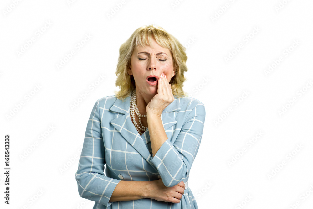 Middle aged woman having terrible tooth pain. Attractive middle aged woman suffering from terrible strong teeth pain, touching cheek with closed eyes standing on white background. Middle aged woman having terrible tooth pain. Attractive middle aged woman suffering from terrible strong teeth pain, touching cheek with closed eyes standing on white background.