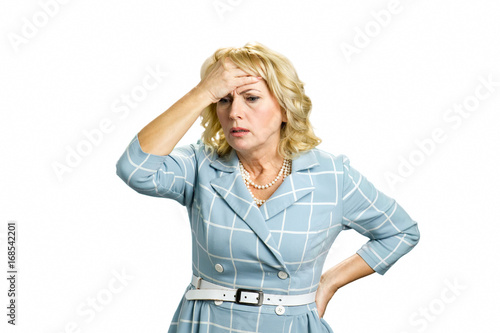 Worried mature woman touching head. Depressed white-skin businesswoman touching her face on white background. Stressed busineswoman with headache, migraine or forgetfulness.
