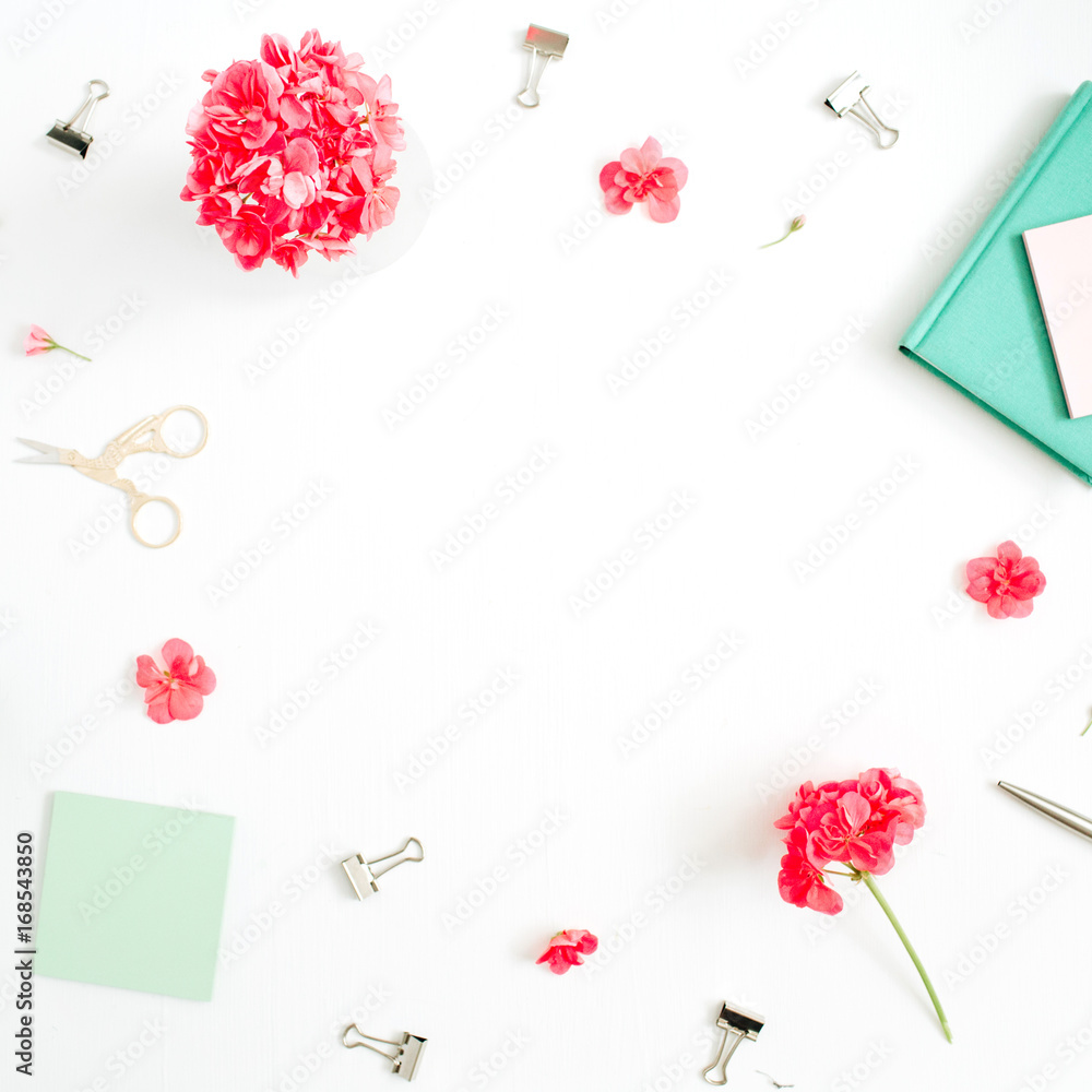 Flat lay fashion office desk with space for text. Female frame workspace with red flowers, accessories, mint diary. Top view feminine background.