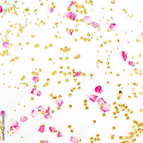 Colorful pattern made of pink rose petals and golden confetti on white background. Flat lay, top view.