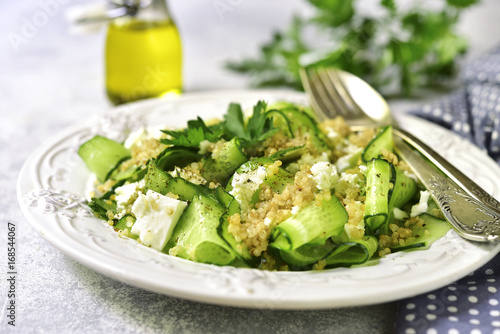 Cucumber salad with quinoa and feta cheese.