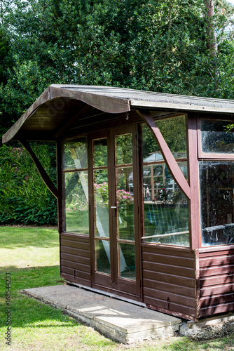 Wooden Glazed Garden Shed In An English Garden