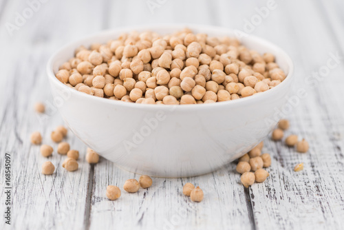 Portion of dried Chickpeas on wooden background, selective focus