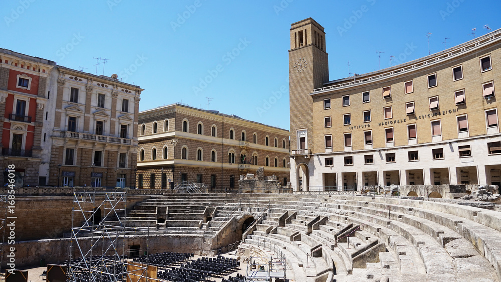 Roman amphitheater with Sedile palace and the column with Sant'Oronzo statue in Lecce Sant'Oronzo square, Apulia, Italy