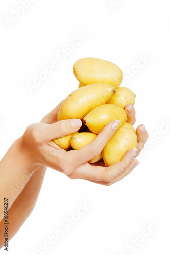 Raw potatores are held by a caucasian woman.