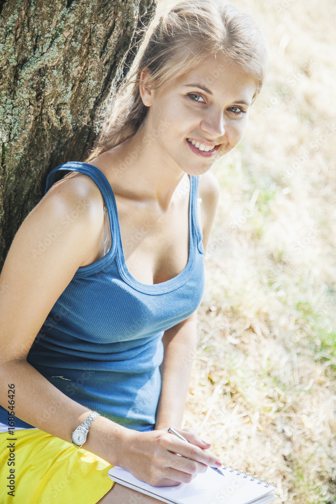 young beautiful girl is preparing for exam outdoors young beautiful girl is preparing for exam outdoors