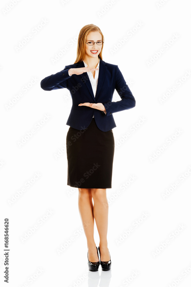Beautiful business woman holding empty copy space between her ha Beautiful business woman holding empty copy space between her ha