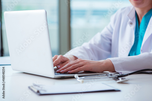 Doctor man working on the computer in lab