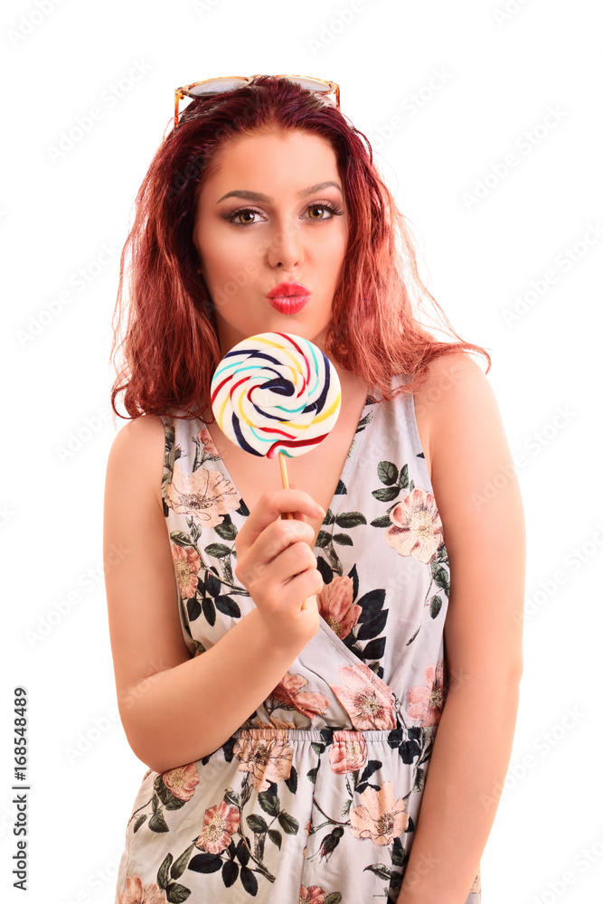 Beautiful young girl holding a lollipop