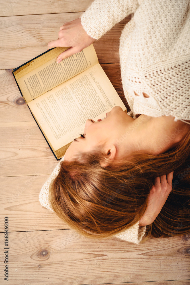 Young beautiful woman lying on the floor with books. Young beautiful woman lying on the floor with books.