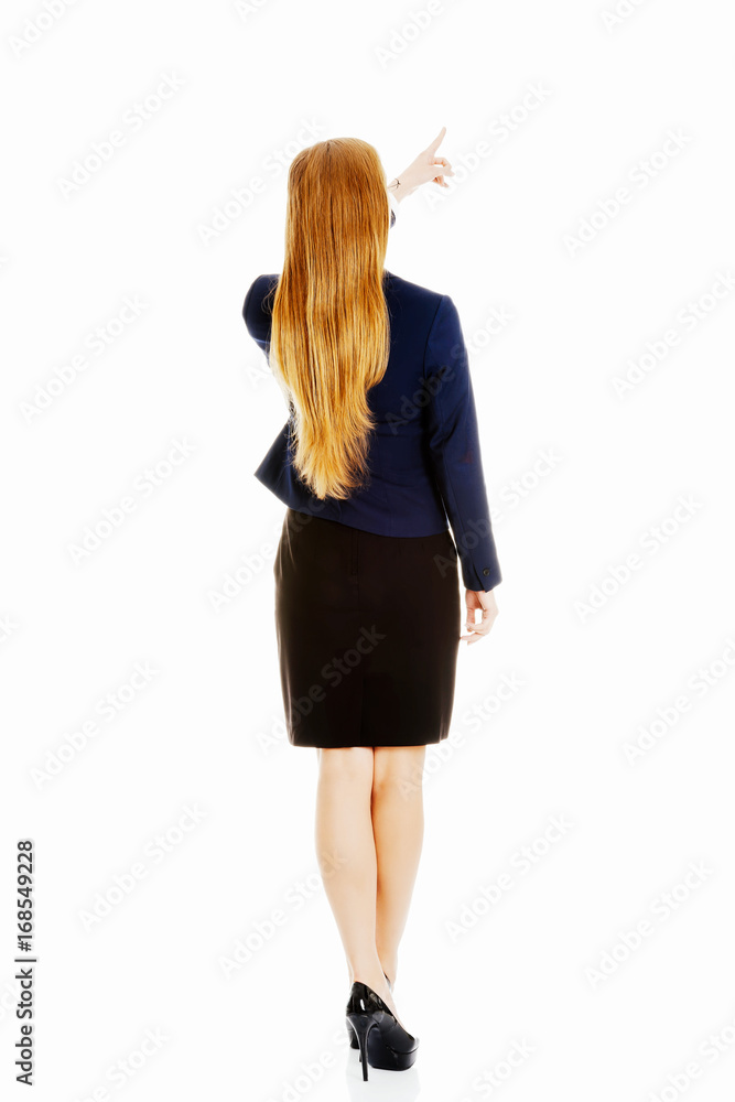 Beautiful business woman pointing up. Beautiful business woman pointing up.