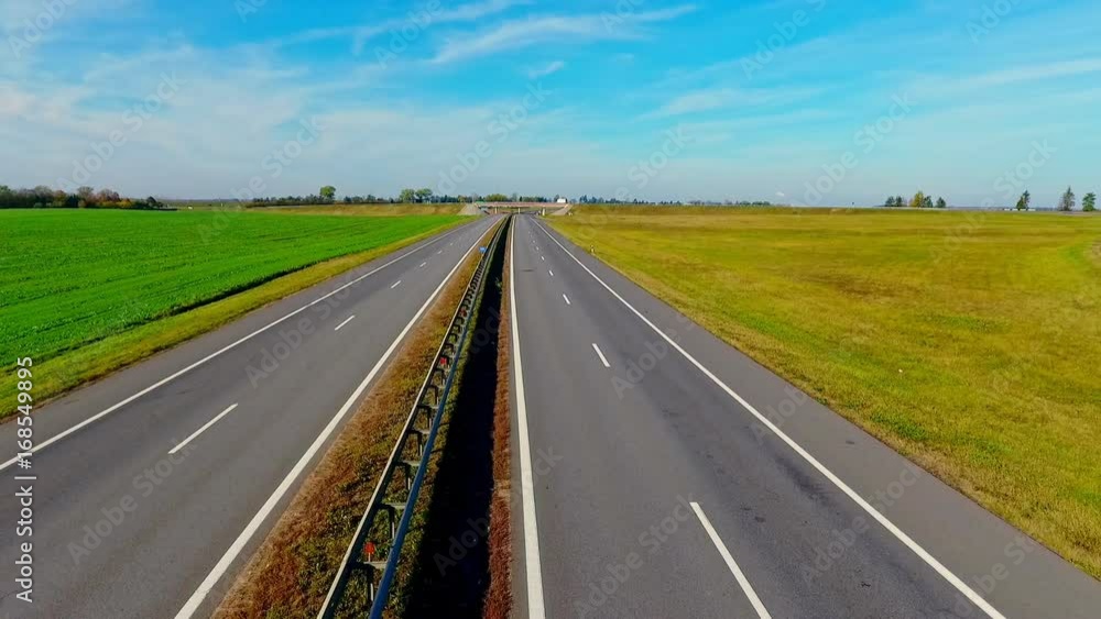 Aerial landscape road in field. Top view straight road. Cars traffic highway sky view. Cars moving on highway road. Highway landscape. Road aerial view Aerial landscape road in field. Top view straight road. Cars traffic highway sky view. Cars moving on highway road. Highway landscape. Road aerial view