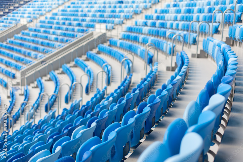 Naklejka premium Rows of blue seats at football stadium. Convenient sitting for all