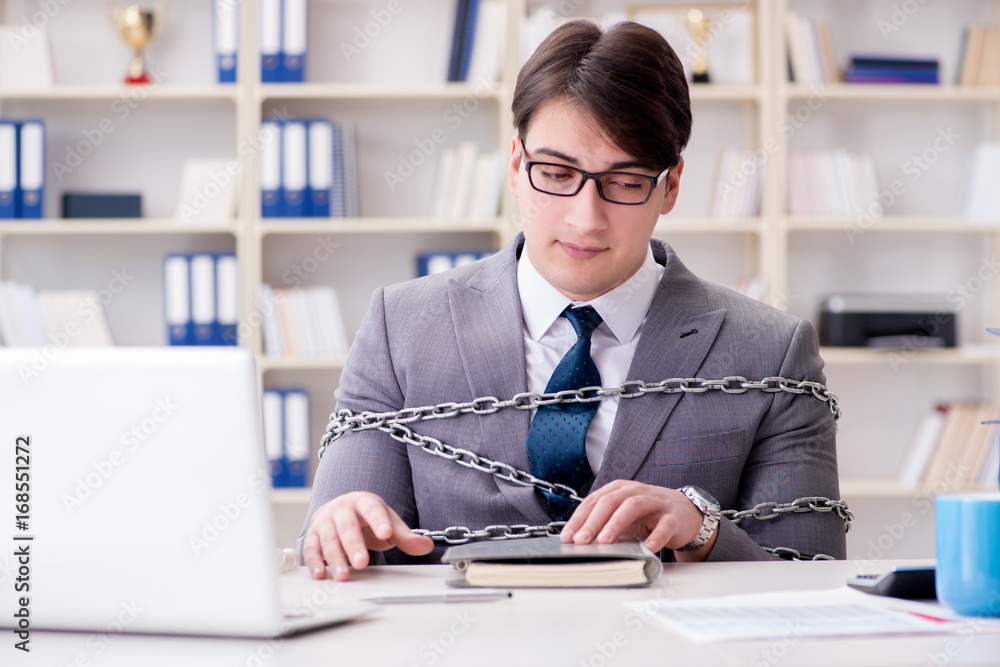 Businessman tied with chains to his work Businessman tied with chains to his work