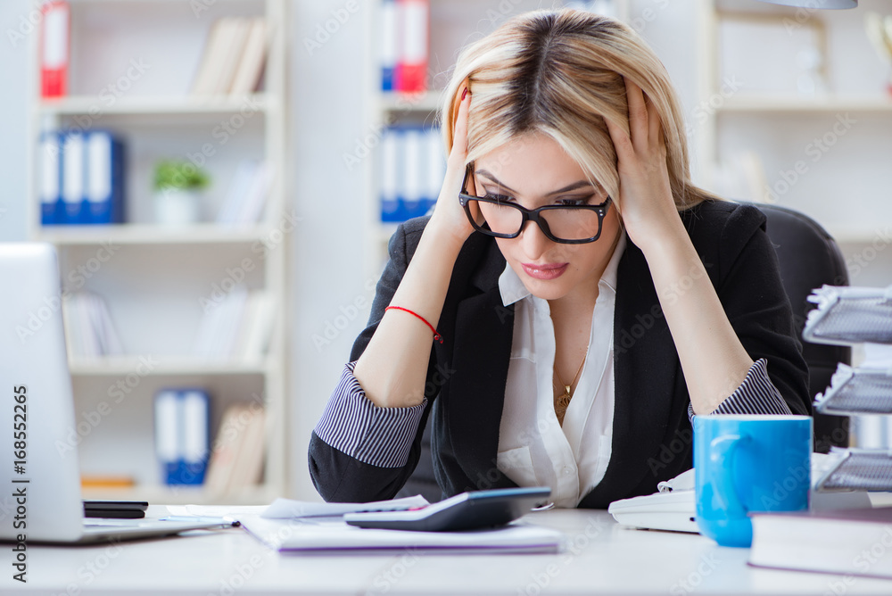 Busineswoman frustrated working in the office Busineswoman frustrated working in the office