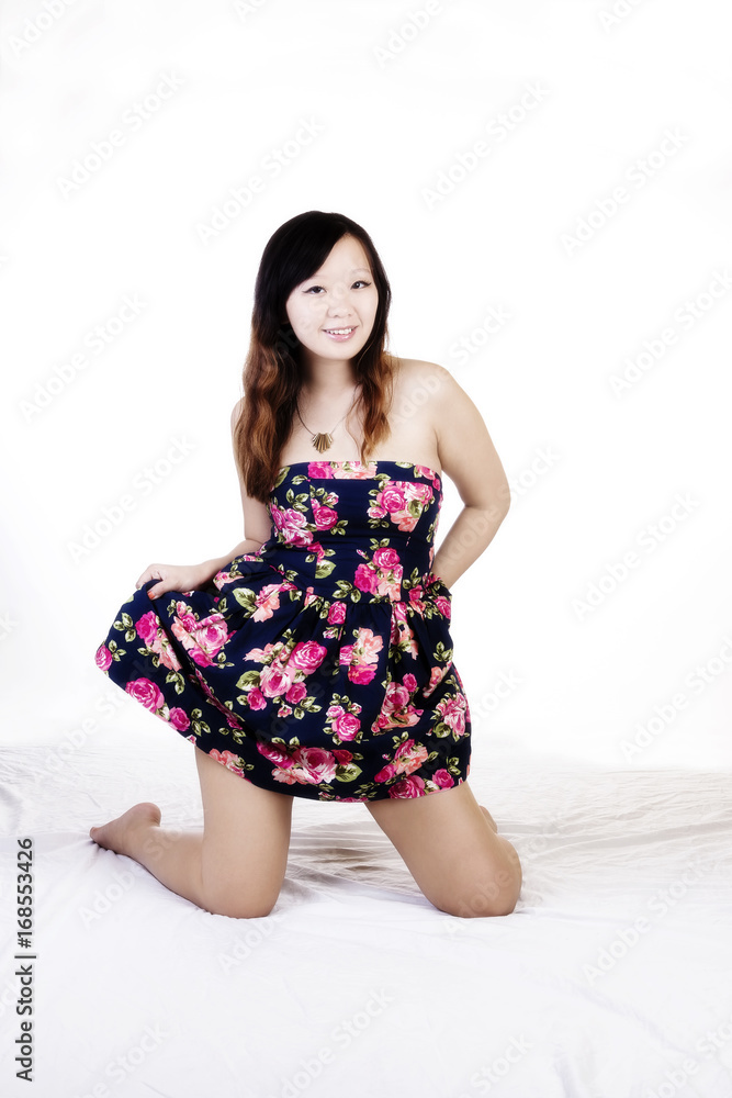 Attractive Chinese American Woman On Knees In Floral Dress Attractive Chinese American Woman On Knees In Floral Dress