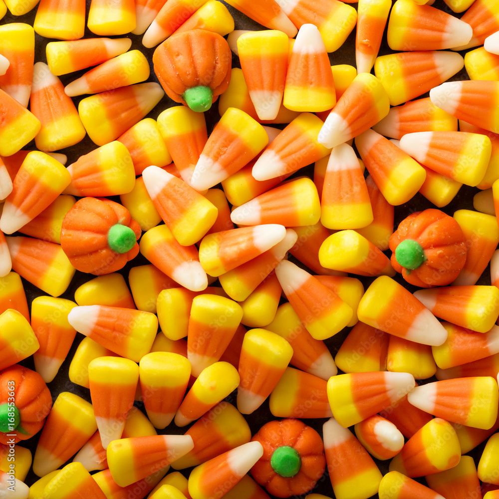 Candy corn and pumpkin Halloween background Candy corn and pumpkin Halloween background