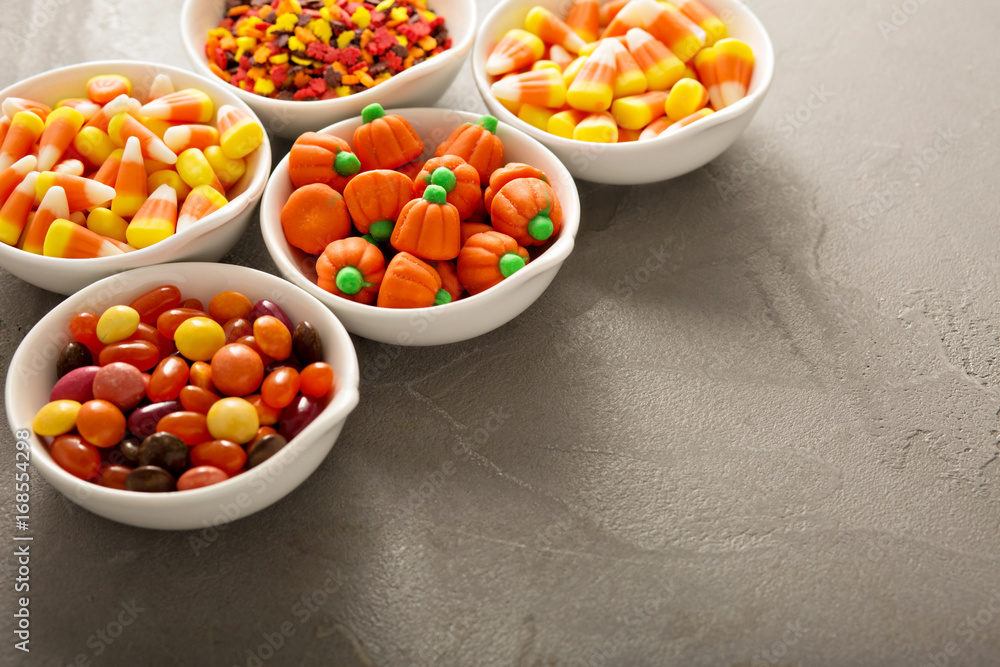 Halloween candy and sprinkles in white bowls Halloween candy and sprinkles in white bowls