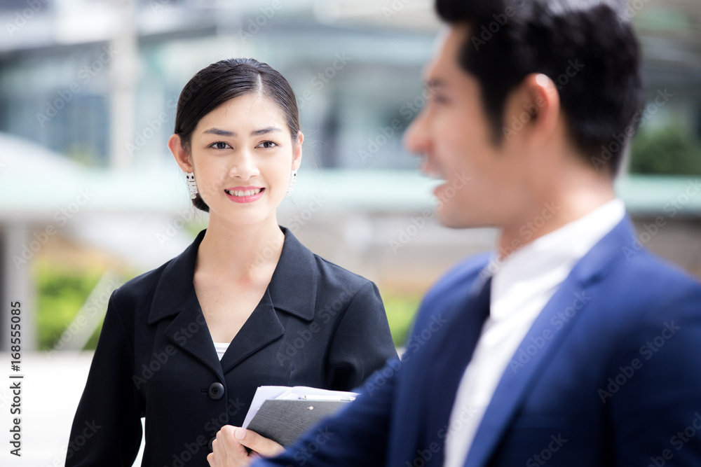 Happy Asian Businesswoman interesting to Assist Project with Businessman. People Working at outdoor place. Woman Working Concept. Happy Asian Businesswoman interesting to Assist Project with Businessman. People Working at outdoor place. Woman Working Concept.