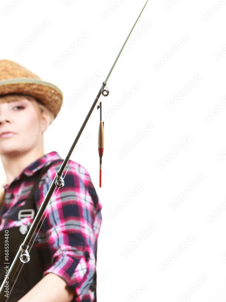 Focused woman looking at fishing rod float Focused woman looking at fishing rod float