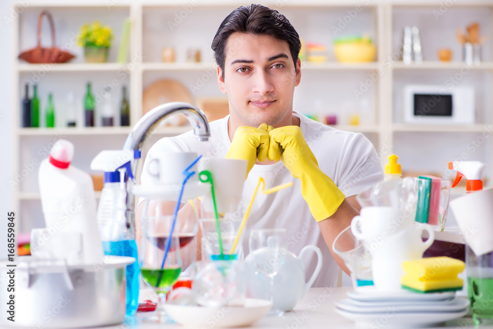 Man enjoying dish washing chores at home Man enjoying dish washing chores at home