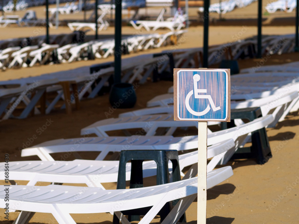 sign on a beach marking places for people with disabilities sign on a beach marking places for people with disabilities